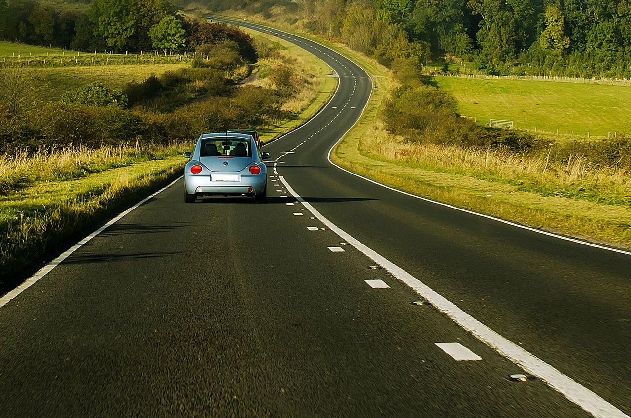 auto che percorre strada di campagna